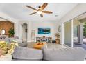 Comfortable living room featuring a large window, ceiling fan and stylish decor at 3872 E Jude Ln, Gilbert, AZ 85298