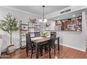 Bright dining area with a wooden table, stylish shelving, and an open view of the kitchen at 4120 N 78Th St # 216, Scottsdale, AZ 85251