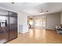 Open kitchen area featuring stainless steel refrigerator and access to a sunroom at 4629 N 78Th Dr, Phoenix, AZ 85033