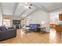 Bright living room with vaulted ceiling, ceiling fan, tile floors and stylish furniture at 4629 N 78Th Dr, Phoenix, AZ 85033