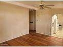 Bright living room featuring hardwood flooring, a ceiling fan, and neutral paint at 5402 E Mckellips Rd # 103, Mesa, AZ 85215