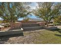Stone community sign for Magic Ranch surrounded by beautiful trees and landscaping at 5761 E Iris Dr, Florence, AZ 85132