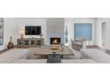 Bright living room featuring a stone fireplace, modern furnishings, and an abundance of natural light at 7405 N Via Camello Del Norte -- # 137, Scottsdale, AZ 85258