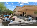 Spacious outdoor living area with comfortable seating, dining space, and a view of the pool at 7438 E Glenn Moore Rd, Scottsdale, AZ 85255