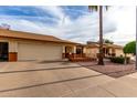 Street view of attractive single-story home with two-car garage, desert landscaping, and inviting front entrance at 8255 E Kiva Ave # 420, Mesa, AZ 85209