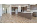 Modern kitchen with stainless steel appliances, center island, and wood-style tile flooring at 852 W Golden Ore Pass, Apache Junction, AZ 85120