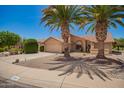 Desert home featuring mature landscaping, a two-car garage, and a beautiful red tile roof at 9243 W Kimberly Way, Peoria, AZ 85382
