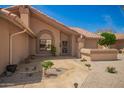 Inviting front porch with decorative stonework, colorful flower beds, and mature plants at 9243 W Kimberly Way, Peoria, AZ 85382