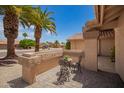 Quaint outdoor sitting area on a front porch with desert landscaping at 9243 W Kimberly Way, Peoria, AZ 85382