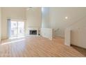 Bright living room features hardwood floors, high ceilings, a fireplace, and sliding glass doors to a balcony at 100 E Fillmore St # 227, Phoenix, AZ 85004