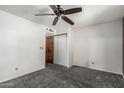 Bedroom with ceiling fan, carpet flooring, and sliding door closet at 1110 E Utopia Rd, Phoenix, AZ 85024