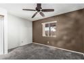 Cozy bedroom featuring plush carpet and a window with views of the outdoors at 1110 E Utopia Rd, Phoenix, AZ 85024