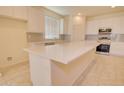 Modern kitchen with white cabinets, stainless steel appliances, and quartz countertops at 1130 E Westwood Dr, Casa Grande, AZ 85122