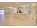Spacious, open concept living and dining area features tile floors, and ample natural light from multiple windows at 1130 E Westwood Dr, Casa Grande, AZ 85122