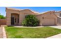 Inviting single-story home with green lawn and front entryway with arched porch at 11411 W Dana Ln, Avondale, AZ 85392