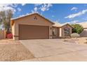Single-story home featuring a wide two-car garage and desert-style landscaping in the front yard at 13414 E Cindy St, Chandler, AZ 85225