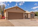 Single-story home featuring a wide two-car garage and desert-style landscaping in the front yard at 13414 E Cindy St, Chandler, AZ 85225