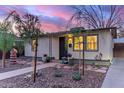Single-story home featuring charming front yard landscaping and decorative potted plants at 146 E 1St St, Mesa, AZ 85201