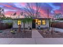 Inviting single-story home with rock landscaping, accent plants, and a cozy front porch at 146 E 1St St, Mesa, AZ 85201