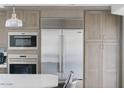 Modern kitchen with stainless steel appliances, microwave and refrigerator with matching wood cabinetry at 14802 N 3Rd Ave, Phoenix, AZ 85023