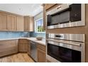 Updated kitchen featuring stainless steel appliances and a window overlooking the backyard at 14802 N 3Rd Ave, Phoenix, AZ 85023