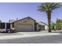 Inviting single-story home with desert landscaping, a two-car garage and an RV trailer parked on the side at 1623 E Krystal St, Casa Grande, AZ 85122