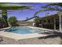 Refreshing backyard pool and patio area with a hammock, grill and covered lounge space at 1623 E Krystal St, Casa Grande, AZ 85122