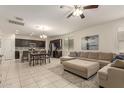 Open-concept kitchen, dining, and living area with tile flooring and stainless steel appliances at 19834 N Tammy St, Maricopa, AZ 85138