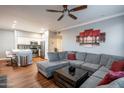 Comfortable living room featuring a large sectional sofa, a decorative ceiling fan, and views to the kitchen at 20100 N 78Th Pl # 3126, Scottsdale, AZ 85255