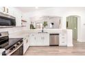 Well-lit kitchen boasts stainless steel appliances, quartz countertops, and an open view to the living area at 2030 S 86Th Dr, Tolleson, AZ 85353