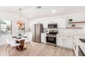 Bright kitchen features stainless steel appliances, white cabinetry, and an adjacent dining area at 2030 S 86Th Dr, Tolleson, AZ 85353