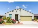 Charming single-story home with a well-maintained front yard and a two-car garage at 21150 N Evergreen Dr, Maricopa, AZ 85138