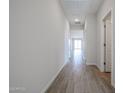 Bright hallway with wood-look tile flooring leading to living areas bathed in natural light at 22085 N Rummler Ln, Maricopa, AZ 85138
