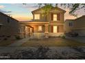 Beautiful two-story home with a covered porch, shutters, and inviting sunset at 2337 E Fraktur Rd, Phoenix, AZ 85040