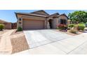Charming single-story home with desert landscaping, and a two-car garage at 23707 W Hess Ave, Buckeye, AZ 85326
