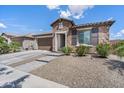 Attractive single-story home with stone accents, a two-car garage, and desert-friendly landscaping at 25421 S 228Th St, Queen Creek, AZ 85142