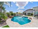 Beautiful backyard with a sparkling pool, lush landscaping, and ample space for relaxation at 25421 S 228Th St, Queen Creek, AZ 85142