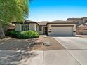 Inviting single-Gathering home featuring a two-car garage and appealing desert landscaping at 271 W Roadrunner Dr, Chandler, AZ 85286