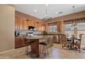Bright kitchen featuring wooden cabinets, granite countertops, a stainless steel dishwasher and a breakfast nook at 3152 E San Pedro Ct, Gilbert, AZ 85234