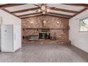 Spacious living area showcasing a brick fireplace and wood beam ceiling at 3238 W Altadena Ave, Phoenix, AZ 85029