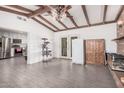 Open living area with wood beams, tile floors, and access to the backyard at 3238 W Altadena Ave, Phoenix, AZ 85029