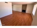 Bright and airy living room features a brick fireplace and wood floors at 3779 E Sweetwater Ave, Phoenix, AZ 85032