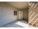 Charming condo entryway featuring a decorative screen door and neutral stucco exterior for easy maintenance at 3830 E Lakewood Pkwy # 1051, Phoenix, AZ 85048