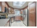 Well-designed kitchen featuring stainless steel appliances, ample cabinetry, and a sunlit tile floor at 3830 E Lakewood Pkwy # 1051, Phoenix, AZ 85048