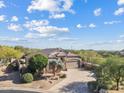 Panoramic aerial view showcases the lush desert landscaping surrounding this beautiful property at 4111 N Starry Pass Cir, Mesa, AZ 85207