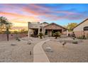 Desert backyard featuring natural landscaping, a patio, outdoor seating, and a hot tub at 4111 N Starry Pass Cir, Mesa, AZ 85207