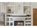 Charming fireplace with decorative shelving and a mosaic tile surround at 4223 E Wildcat Dr, Cave Creek, AZ 85331