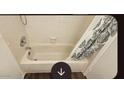 Clean bathtub setup with shower head and patterned curtain at 4601 N 102Nd Ave # 2202, Phoenix, AZ 85037