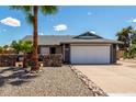 Charming single-Gathering home with a two-car garage and desert landscaping, including a tall palm tree at 5601 W Whitten St, Chandler, AZ 85226
