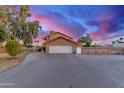 Exterior view of home, showcasing the two-car garage and spacious driveway at 6550 N 7Th St, Phoenix, AZ 85014